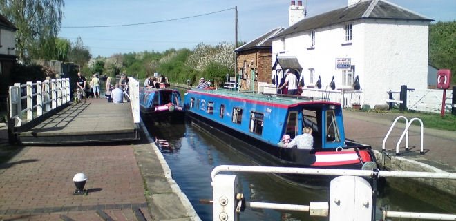 Two Canalboats Entering Lock in England
